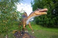 A sculpture of a Spinosaurus in the paleontologic park in the sunny August afternoon