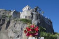 Sculpture of St Antonino Abate and red anthurium flowers in Sorrento, Italy Royalty Free Stock Photo