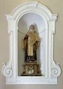 Sculpture of St. Teresa of Avila in a niche on a side wall of the Church of St. Mary of Graces in Varenna, Italy.