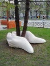 Sculpture on the street. White hands are holding a tree sculpture. The symbol of conservation and protection of nature. eco consep
