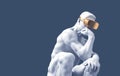 Sculpture Thinker With Golden VR Glasses Over Blue Background