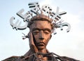 Sculpture of thinking man with the major currencies symbols