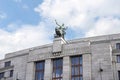 Sculpture of a torchbearer and a lion on a 30s style building in Prague Royalty Free Stock Photo