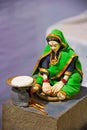 Sculpture of traditional Maharashtrian woman making rotis on a traditional oven