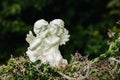 Sculpture of two angels on flowers garland Royalty Free Stock Photo