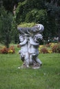 Sculpture of two children holdin flowers