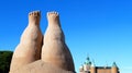 Sculpture of two human feet in front of a cityscape background of modern buildings Royalty Free Stock Photo