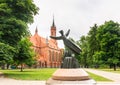 Sculpture Vyturys (Lark) and the Church of the Holy Virgin Mary Scapular. Druskininkai