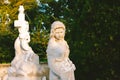 Sculpture of a woman at old cemetery. Close Up of stone figure and cross monument at cemetery. Old stone Graveyard statue on funer