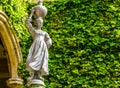 Sculpture of a women collecting water in a urn and carrying it on her head, African garden decorations and architecture