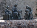 Sculpture in Offida, three women making traditional bobbin lace