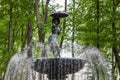 A sculpture of a young girl with an umbrella. A fountain in a city park, Kaluga, Russia