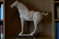 Sculptured rock horse statue on Book shelf for decoration in room