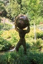 Sculptured topiary of man holding the earth (Atlas mythology) in the garden of animals in Merano, South Tyrol, Italy Royalty Free Stock Photo