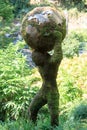 Sculptured topiary of man holding the earth (Atlas mythology) in the garden of animals in Merano, South Tyrol, Italy Royalty Free Stock Photo