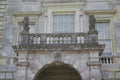 Sculptured window balcony with lion statues.