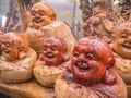 sculptured wood Smiling Buddha statue with raindrop on the statue on tianzi mountain at Zhangjiajie National Forest Park