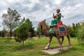 Sculptures in city park, camel rider