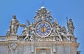 Sculptures and clock on the facade of Saint Peter basilica