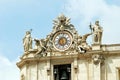 Sculptures and clock on the facade of Vatican city works Royalty Free Stock Photo