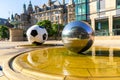 The sculptures of football ball and stainless steel spheres and Sheffield Town Hall