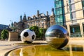 The sculptures of football ball and stainless steel spheres and Sheffield Town Hall