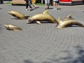 Sculptures of gold-colored,jumping dolphins on a square in Odessa, Ukraine