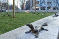 Sculptures of lizards on a green lawn in the city center of Amsterdam