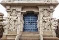 The sculptures of mythological creatures and gods at the entrance to an ancient Indian temple