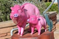 Sculptures of pink pigs on the central street of the city