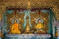 Sculptures of a seated Buddha in one of the pagodas of the Shwedagon temple complex. Yangon, Myanmar