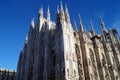 Sculptures and spires of the Cathedral, partial view at an angle of the front and side exterior, Milan, Italy Royalty Free Stock Photo