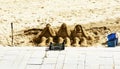 Sculptures of three sand monkeys on a beach in the province of Barcelona