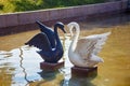 Sculptures of the white and black swan in city park of Almaty.