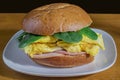 scramble egg with canadian bacon and spinach on brioche roll