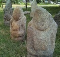 Scythian stone women on the lawn near the city museum. Ancient gray stone sculptures.