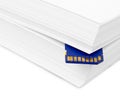 Sd memory card with a stack of printer paper. Hardcopy backup or Royalty Free Stock Photo