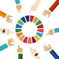 SDG sustainable development goals 17 goal hand pointing team focus concept discus on colorful circle