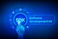 SDK. Software development kit programming language technology concept on virtual screen. Technology Concept. Robotic hand touching Royalty Free Stock Photo