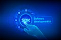 SDK. Software development kit programming language technology concept on virtual screen. Technology Concept. Robotic hand touching Royalty Free Stock Photo