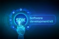SDK. Software development kit programming language technology concept on virtual screen. Technology Concept. Robotic hand touching Royalty Free Stock Photo