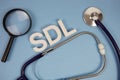 SDL Self-Directed Learning alphabet letters with Stethoscope and magnifying glass on blue background Royalty Free Stock Photo