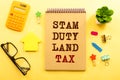 SDLT - Stamp Duty Land Tax write on a card on office desk