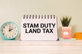 SDLT - Stamp Duty Land Tax write on a card on office desk