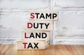 SDLT - Stamp Duty, Land Tax written on blocks on an office desk Royalty Free Stock Photo