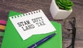 SDLT - Stamp Duty for Land Tax is written on a notebook on a green background