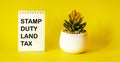 SDLT - Stamp Duty for Land Tax is written on a notebook on a yellow background Royalty Free Stock Photo