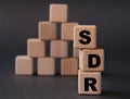 SDR - acronym on wooden cubes on a dark background