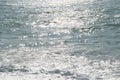 Waves on the sea. Sunny glare on the water. Marine background.