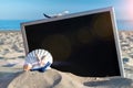 Sea background. Globe, seashell, airplane and starfish near black desk on sea beach in sunny day. Exotic tropical beach with copy Royalty Free Stock Photo